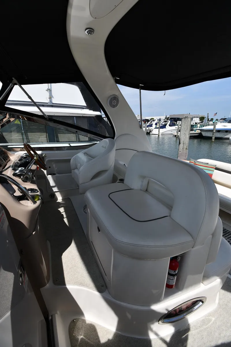 Slide: The Image of 2004 Sea Ray 360 Sundancer cockpit with white seating, docked at marina. - 19