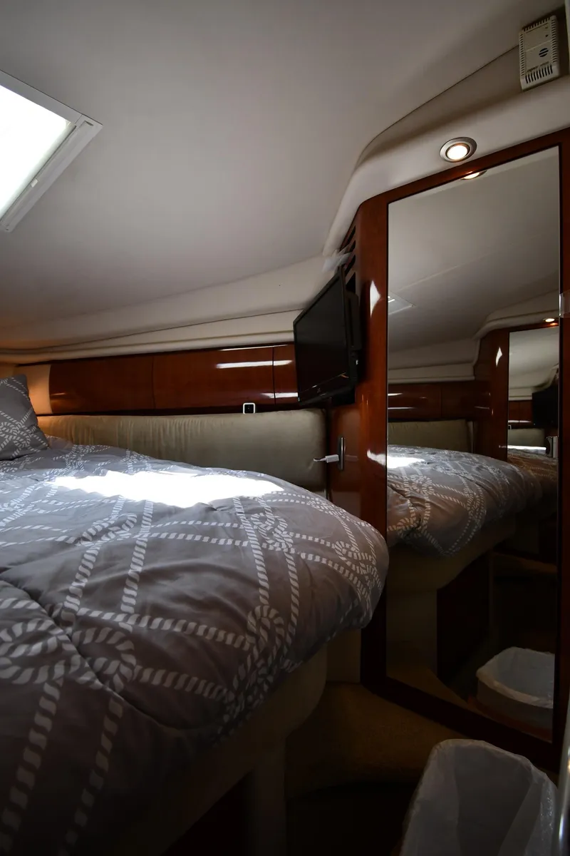Slide: The Image of 2004 Sea Ray 360 Sundancer cabin interior with bed, mirror, and TV. - 33