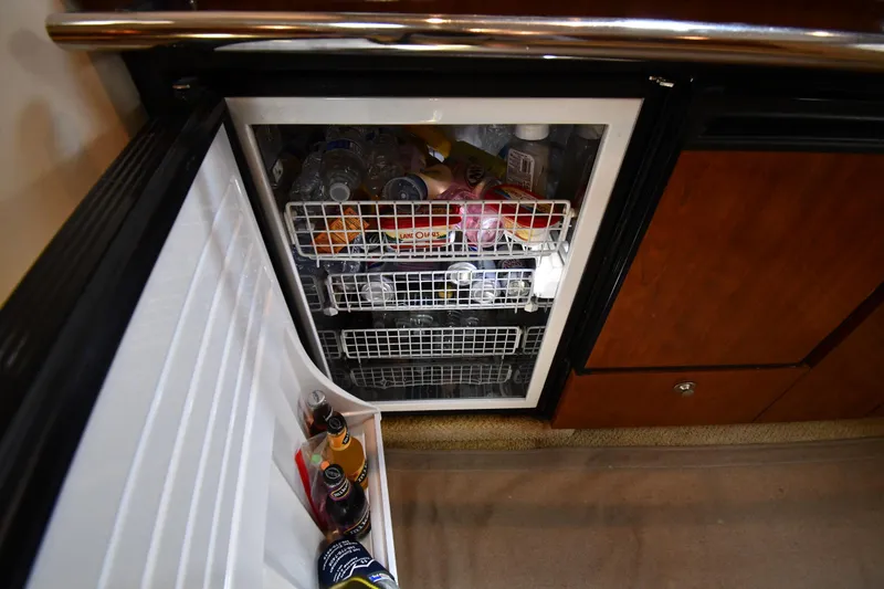 Slide: The Image of 2004 Sea Ray 360 Sundancer refrigerator stocked with beverages and snacks. - 49