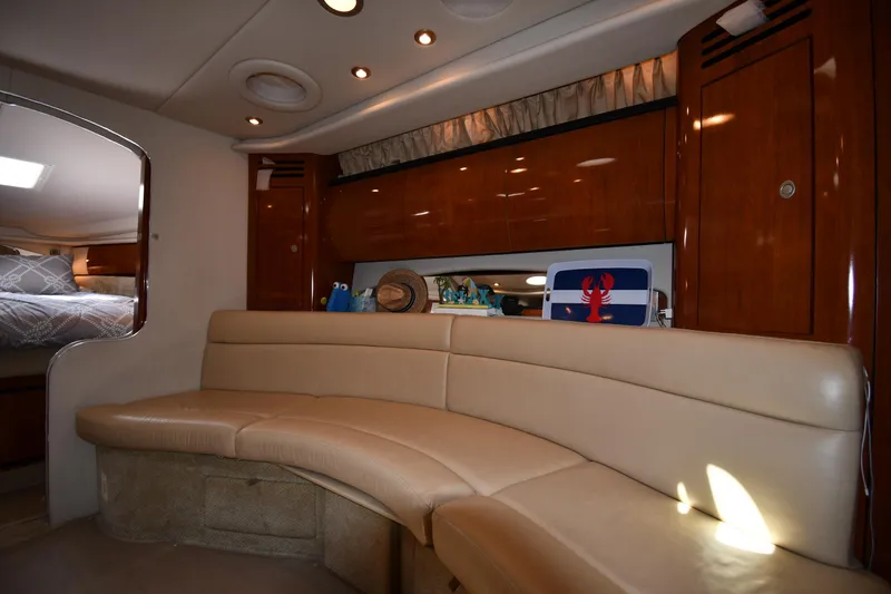 Slide: The Image of Interior of 2004 Sea Ray 360 Sundancer with beige seating and wooden cabinetry. - 38