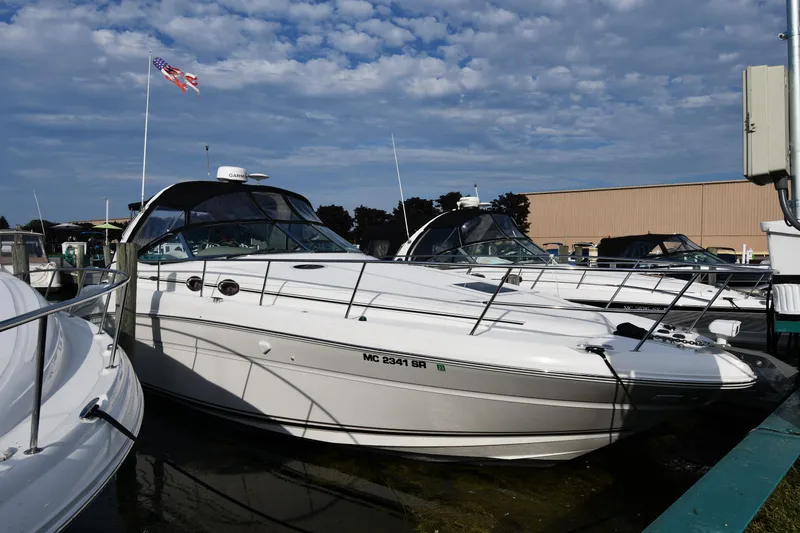 The Image of 2004 Sea Ray 360 Sundancer yacht docked under a cloudy sky. - 0