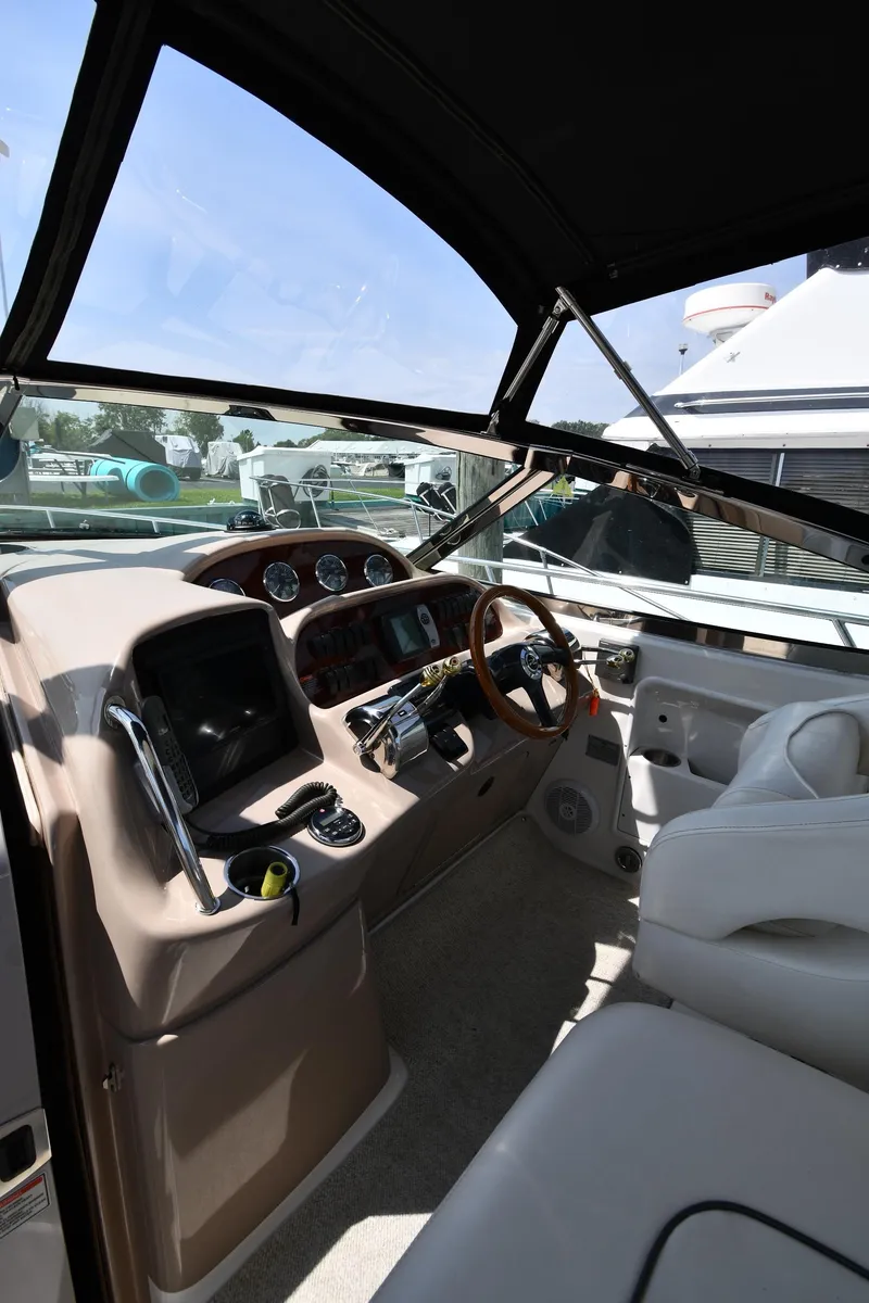 Slide: The Image of 2004 Sea Ray 360 Sundancer helm with modern controls and comfortable seating. - 15