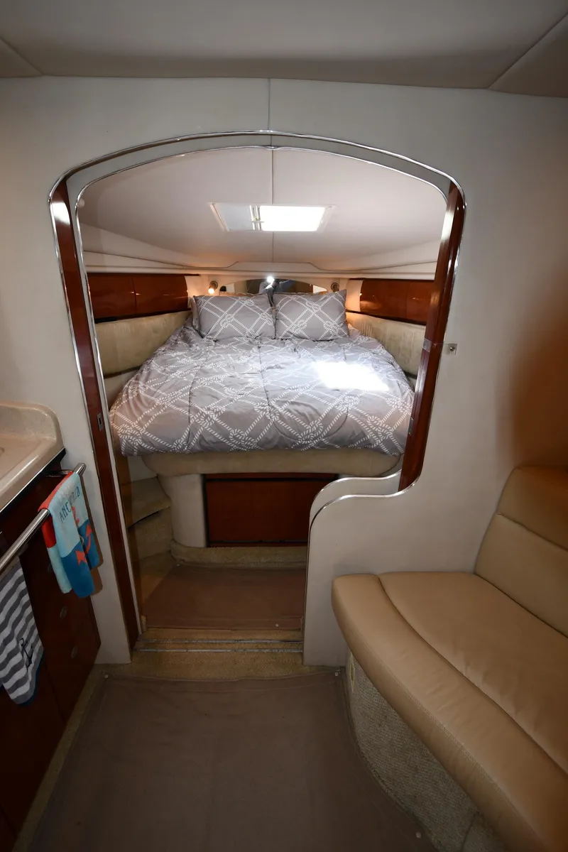 Slide: The Image of 2004 Sea Ray 360 Sundancer cabin with bed, cozy seating, and modern interior design. - 31