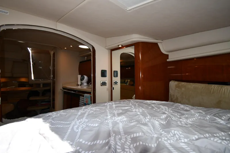 Slide: The Image of Interior of 2004 Sea Ray 360 Sundancer yacht, featuring a cozy bedroom and kitchenette. - 35