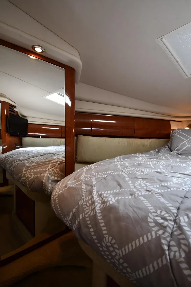 Slide: The Image of 2004 Sea Ray 360 Sundancer cabin interior with bed and mirror. - 34