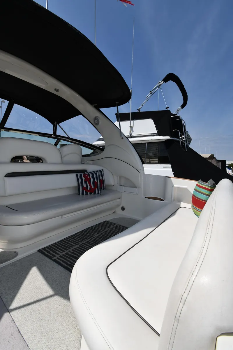 Slide: The Image of 2004 Sea Ray 360 Sundancer yacht interior with white seating and colorful cushions. - 21