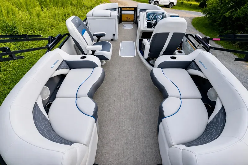 Slide: The Image of 2023 Barletta Corsa 21Q pontoon boat interior with plush seating and modern dashboard. - 12