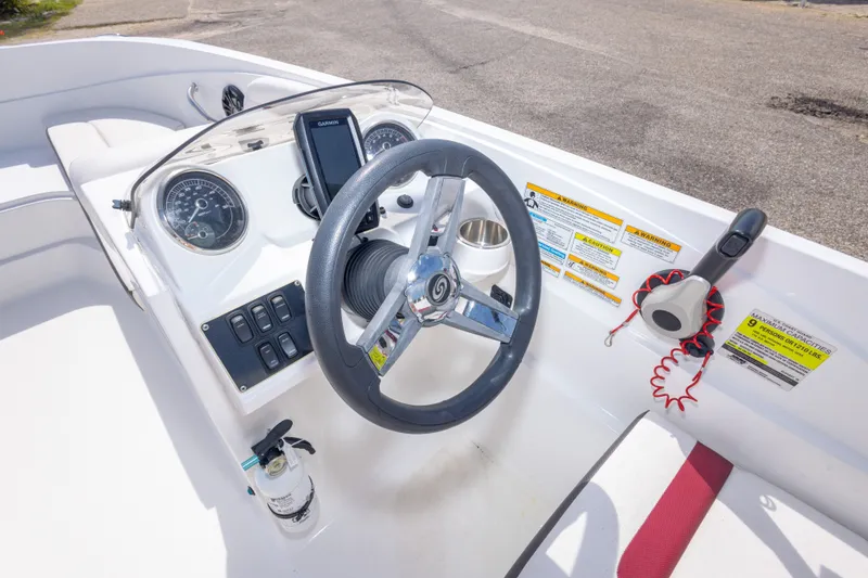 Slide: The Image of 2021 Hurricane SunDeck Sport 185 OB boat dashboard with steering wheel and controls. - 23
