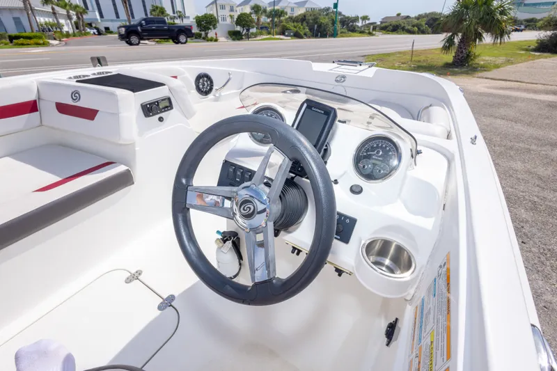 Slide: The Image of 2021 Hurricane SunDeck Sport 185 OB boat interior with steering wheel and dashboard controls. - 24
