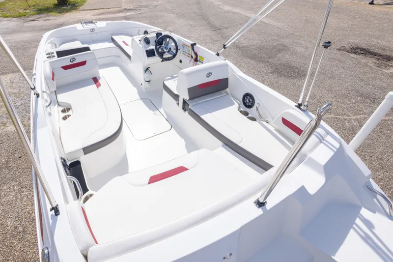 Slide: The Image of 2021 Hurricane SunDeck Sport 185 OB boat interior with white seating and steering console. - 18