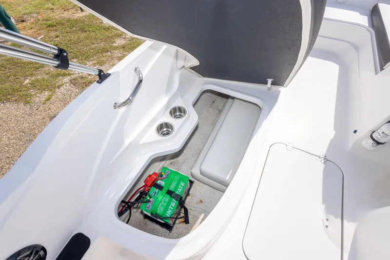 Slide: The Image of 2021 Hurricane SunDeck Sport 185 OB boat interior with storage compartment and battery. - 37