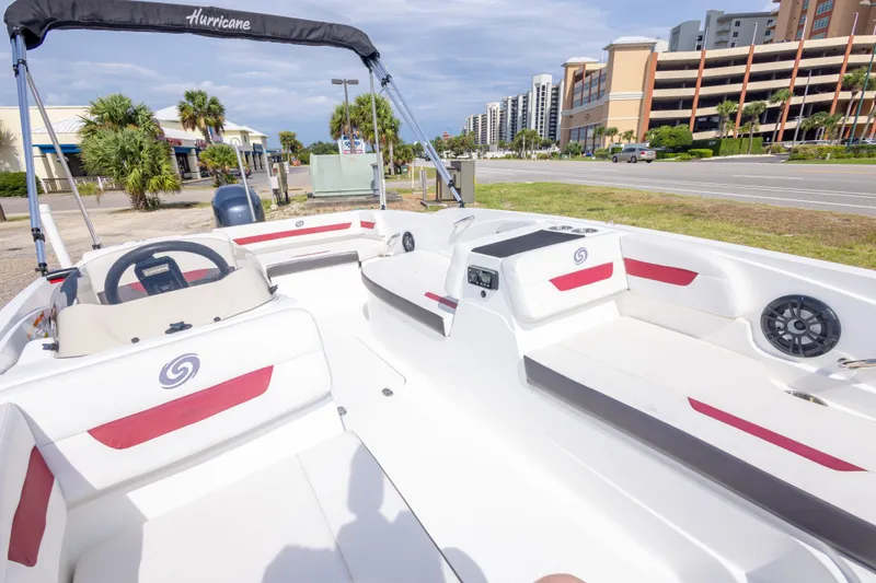 Slide: The Image of 2021 Hurricane SunDeck Sport 185 OB boat interior with seating and steering wheel. - 28