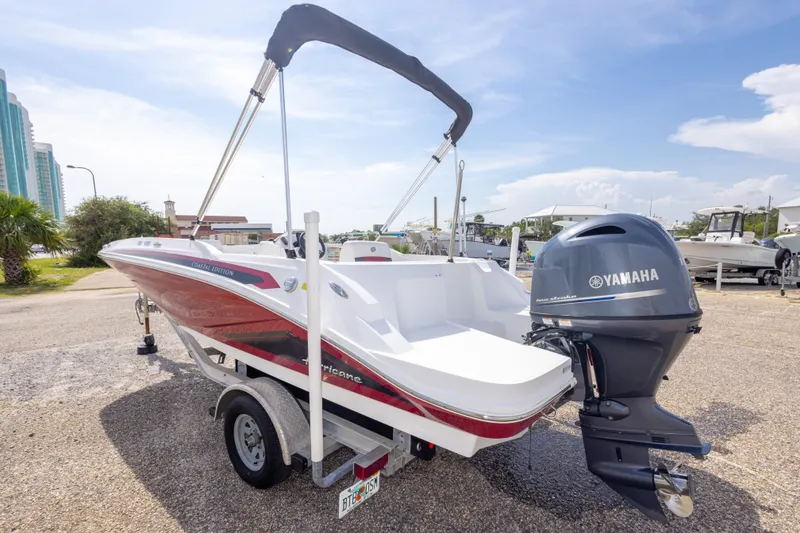 Slide: The Image of 2021 Hurricane SunDeck Sport 185 OB boat with Yamaha engine, parked outdoors on a trailer. - 41