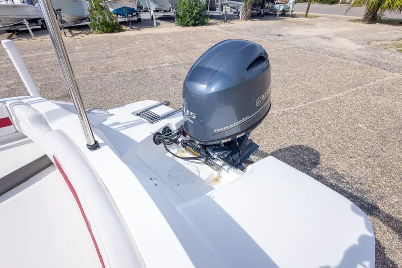 Slide: The Image of 2021 Hurricane SunDeck Sport 185 OB with Yamaha outboard motor in a parking area. - 33