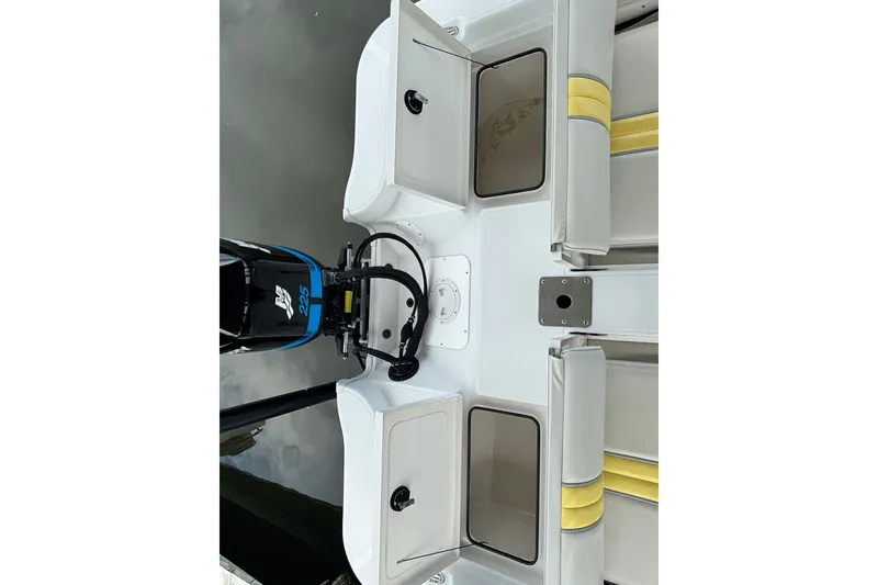 Slide: The Image of 2002 Ranger 2300 Bay Ranger boat interior with motor and seating. - 19