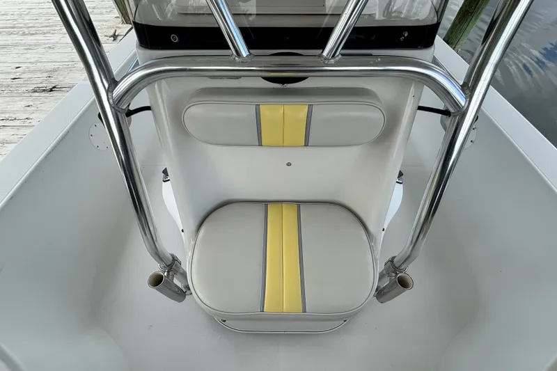 Slide: The Image of 2002 Ranger 2300 Bay Ranger boat seat with yellow-striped upholstery and stainless steel frame. - 14