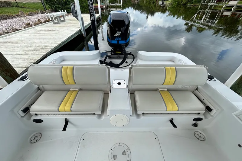 Slide: The Image of 2002 Ranger 2300 Bay Ranger boat interior with dual seats and outboard motor. - 18