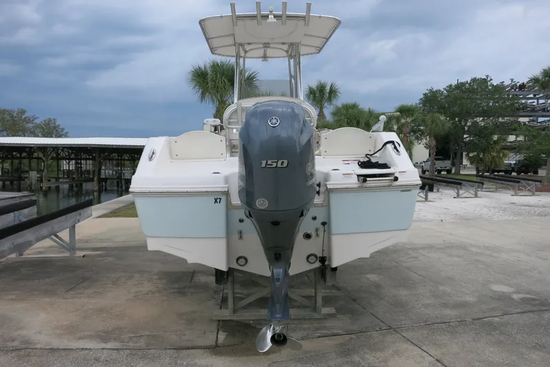 Slide: The Image of 2019 Robalo R200 Center Console boat with Yamaha 150 engine, docked outdoors. - 8