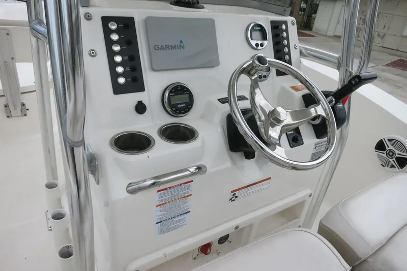 Slide: The Image of 2019 Robalo R200 Center Console boat dashboard with Garmin navigation system and steering wheel. - 20