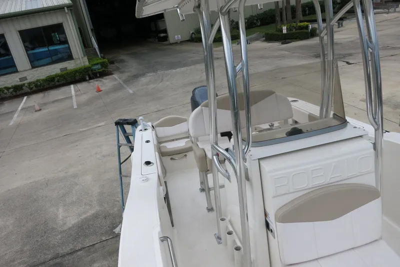 Slide: The Image of 2019 Robalo R200 Center Console boat parked in a marina. - 18