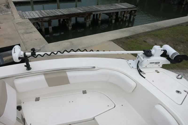 Slide: The Image of 2019 Robalo R200 Center Console with Minn Kota trolling motor at dock. - 15