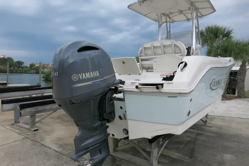 Slide: The Image of 2019 Robalo R200 Center Console boat with Yamaha engine, docked near water. - 9