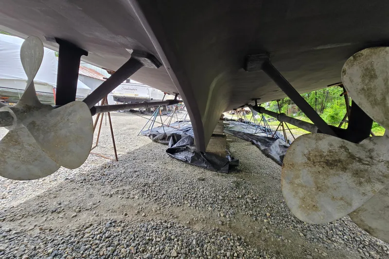 Slide: The Image of Underside view of 1980 Hatteras 70 Motor Yacht with visible propellers and supports. - 44