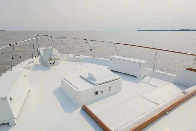 Slide: The Image of Bow view of 1980 Hatteras 70 Motor Yacht on calm waters. - 16