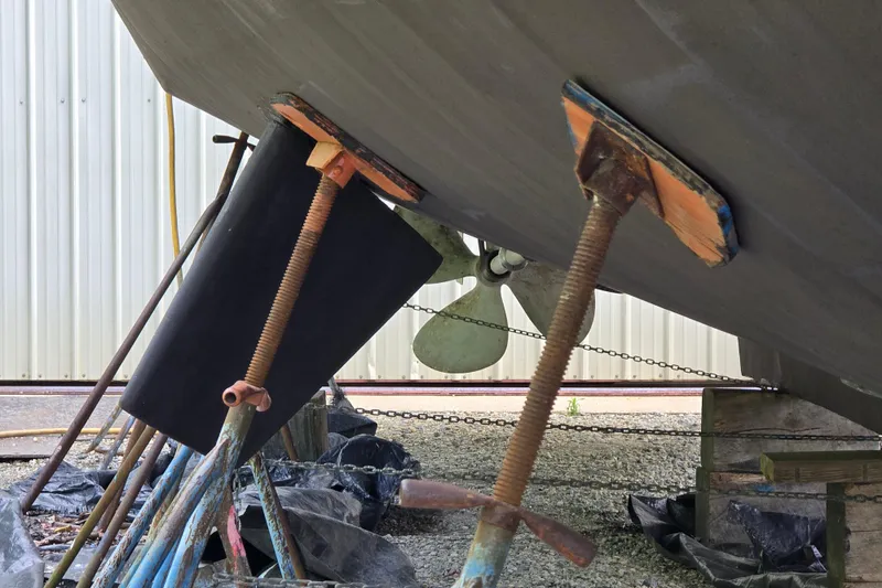 Slide: The Image of Bottom view of a 1980 Hatteras 70 Motor Yacht on supports, showing propeller and rudder. - 53