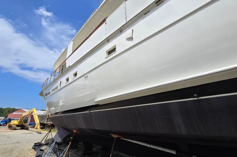 Slide: The Image of 1980 Hatteras 70 Motor Yacht on dry dock under clear blue sky. - 47