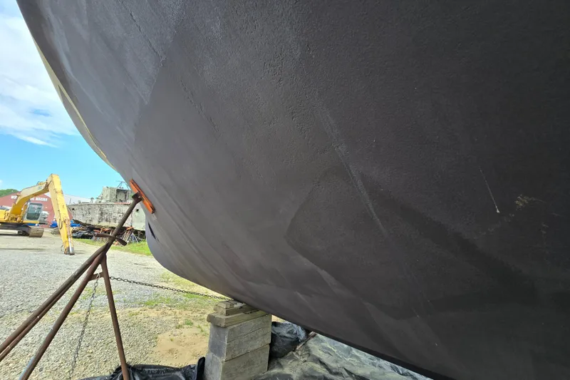 Slide: The Image of Bottom view of a 1980 Hatteras 70 Motor Yacht on dry dock. - 34