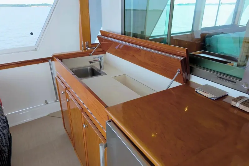 Slide: The Image of 1980 Hatteras 70 Motor Yacht interior with wooden cabinetry and sink. - 14