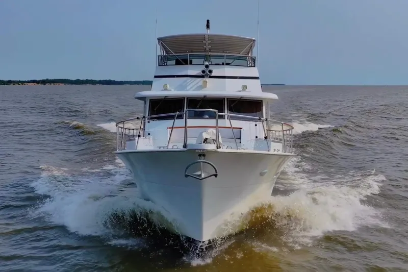 The Image of 1980 Hatteras 70 Motor Yacht cruising on open water, front view. - 0