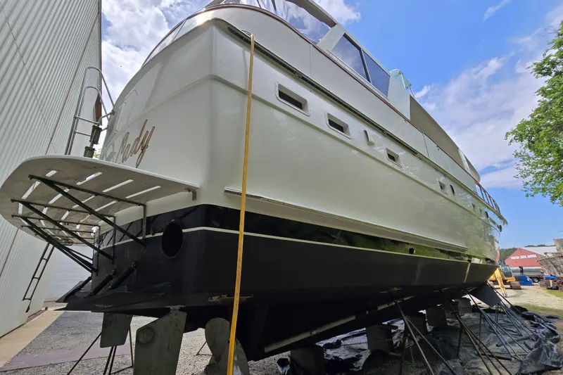 Slide: The Image of 1980 Hatteras 70 Motor Yacht on dry dock, showcasing sleek design and sturdy construction. - 45