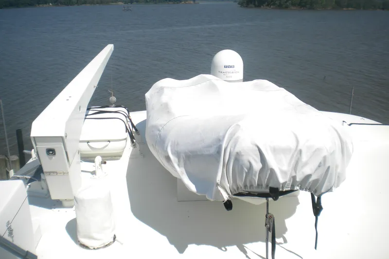 Slide: The Image of 1980 Hatteras 70 Motor Yacht deck with covered equipment and water view. - 20