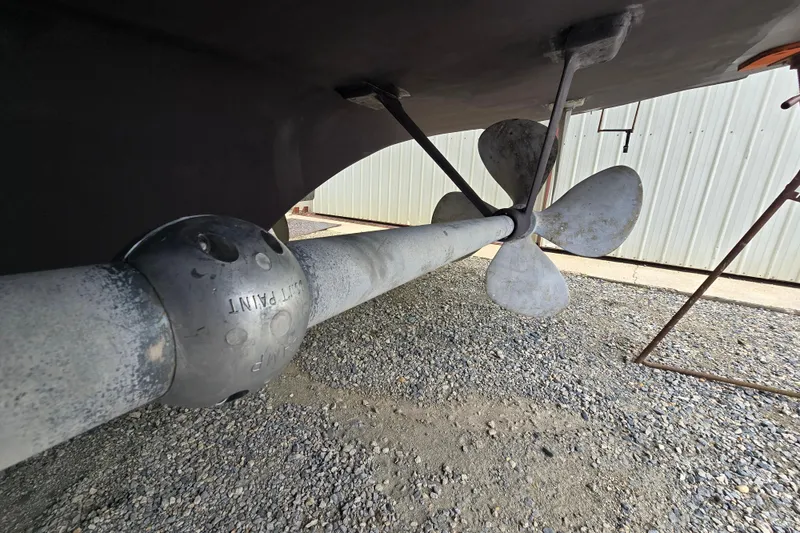 Slide: The Image of Propeller and shaft of a 1980 Hatteras 70 Motor Yacht on gravel surface. - 38