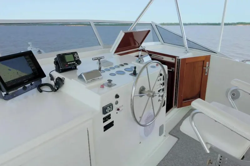 Slide: The Image of Helm of 1980 Hatteras 70 Motor Yacht with navigation equipment and steering wheel. - 17