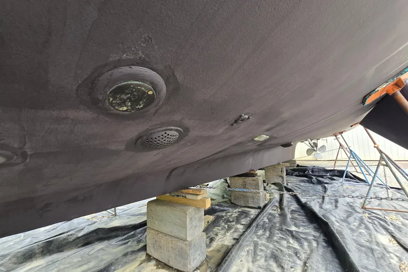 Slide: The Image of Underside of 1980 Hatteras 70 Motor Yacht on blocks, showing hull details. - 33