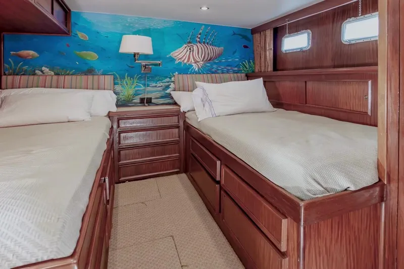 Slide: The Image of Cozy twin cabin with ocean-themed mural in 1980 Hatteras 70 Motor Yacht. - 22
