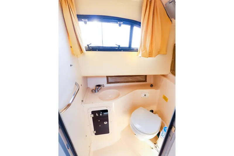 Slide: The Image of Interior of 2015 Grady-White Sailfish 282 boat bathroom with sink and toilet. - 40