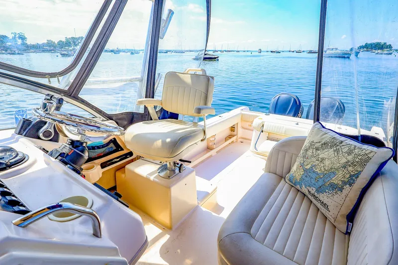 Slide: The Image of Interior of 2015 Grady-White Sailfish 282 boat with helm and seating, overlooking serene waters. - 21