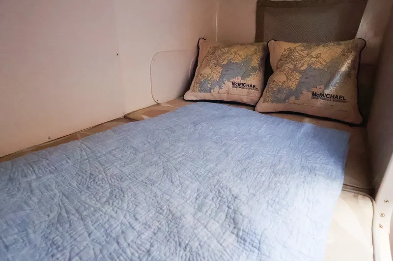 Slide: The Image of Cozy cabin bed in 2015 Grady-White Sailfish 282 boat with nautical-themed pillows. - 41