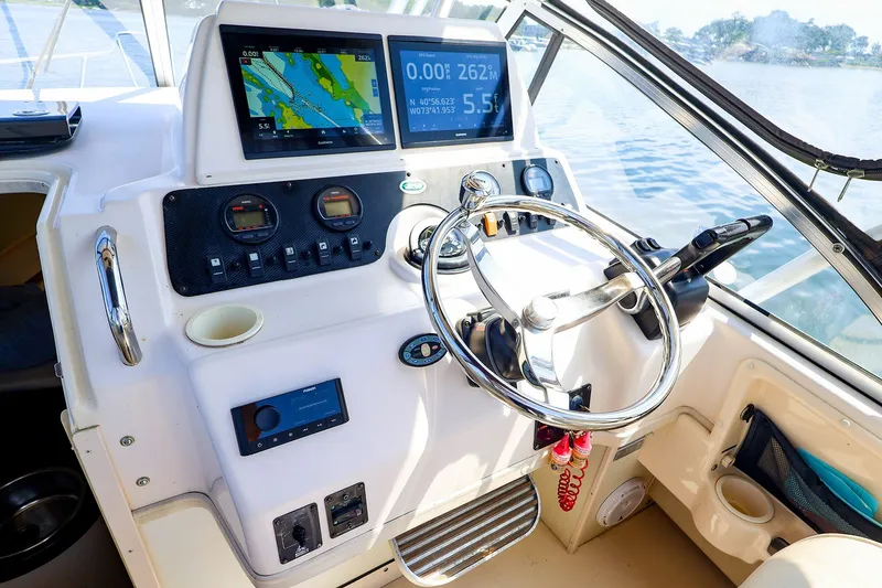 Slide: The Image of Helm of 2015 Grady-White Sailfish 282 with navigation screens and steering wheel. - 22