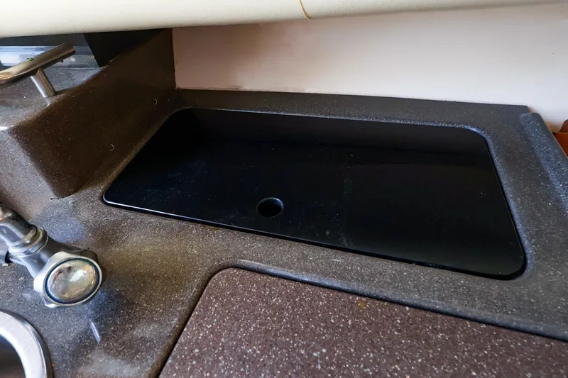 Slide: The Image of Sink area on a 2015 Grady-White Sailfish 282 boat, featuring a sleek countertop design. - 35