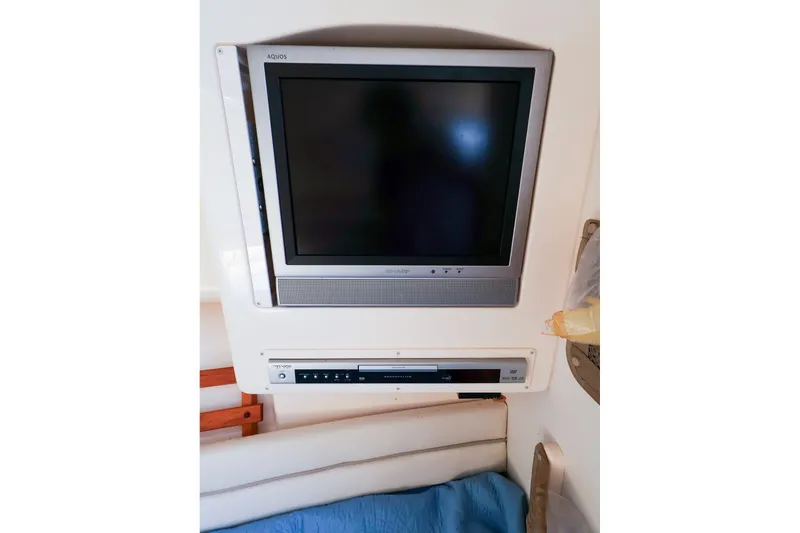 Slide: The Image of Flat-screen TV and DVD player in 2015 Grady-White Sailfish 282 cabin interior. - 38