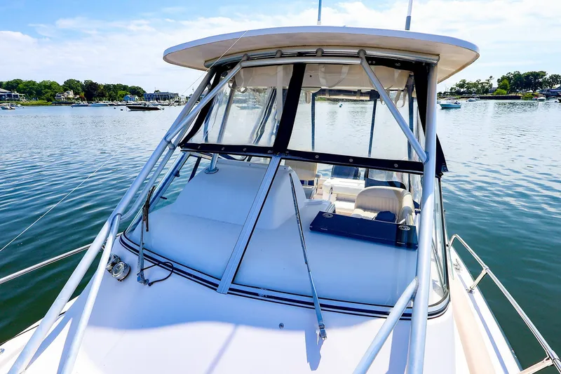 Slide: The Image of 2015 Grady-White Sailfish 282 boat on calm water, showcasing cockpit and canopy. - 16