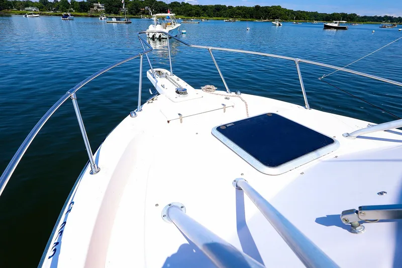Slide: The Image of Bow view of 2015 Grady-White Sailfish 282 on calm water, surrounded by boats. - 15