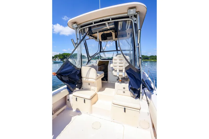 Slide: The Image of 2015 Grady-White Sailfish 282 boat interior with seating, clear skies, and water view. - 43