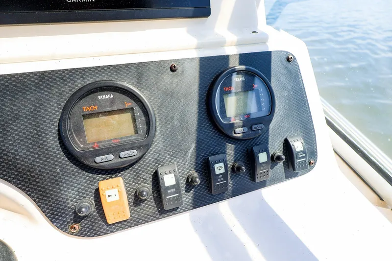 Slide: The Image of Dashboard of 2015 Grady-White Sailfish 282 boat with Yamaha tachometers and control switches. - 25