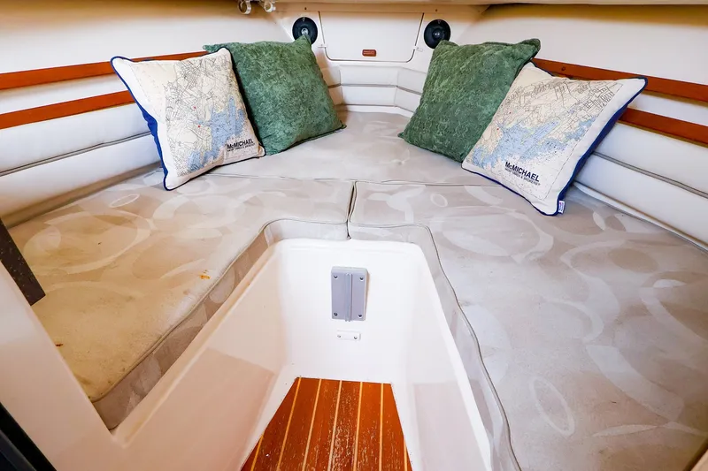 Slide: The Image of Interior cabin of 2015 Grady-White Sailfish 282 with cushions and decorative pillows. - 42